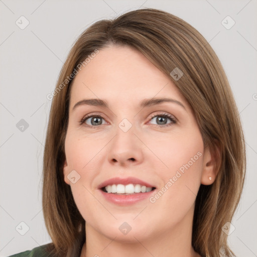 Joyful white young-adult female with medium  brown hair and green eyes