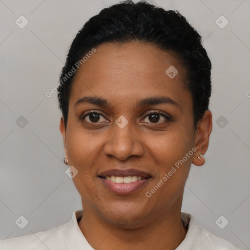 Joyful black young-adult female with short  black hair and brown eyes