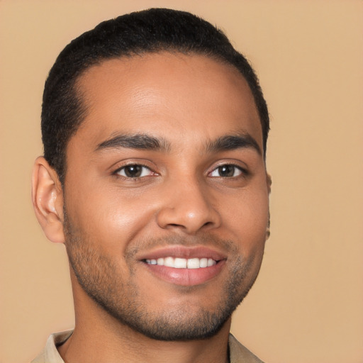 Joyful latino young-adult male with short  brown hair and brown eyes