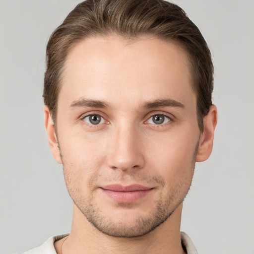 Joyful white young-adult male with short  brown hair and grey eyes