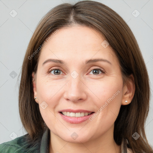 Joyful white young-adult female with medium  brown hair and grey eyes