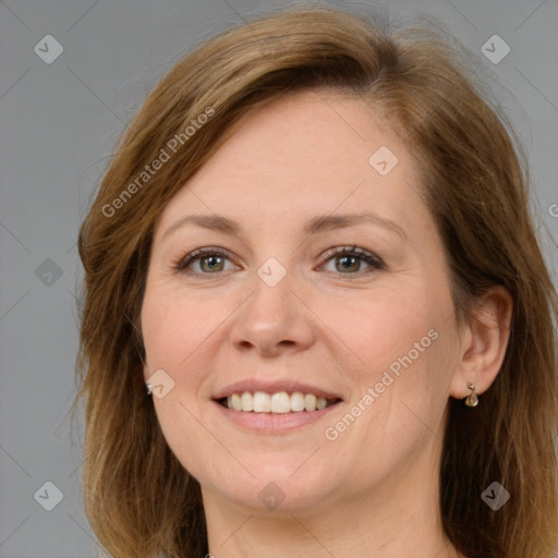 Joyful white adult female with long  brown hair and grey eyes