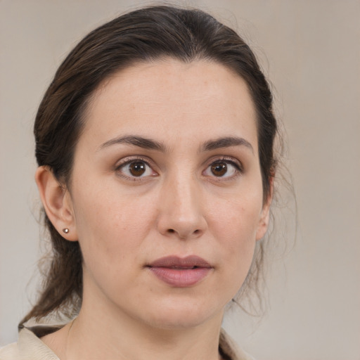 Joyful white young-adult female with medium  brown hair and brown eyes