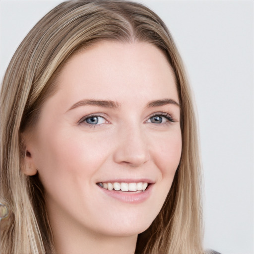 Joyful white young-adult female with long  brown hair and blue eyes