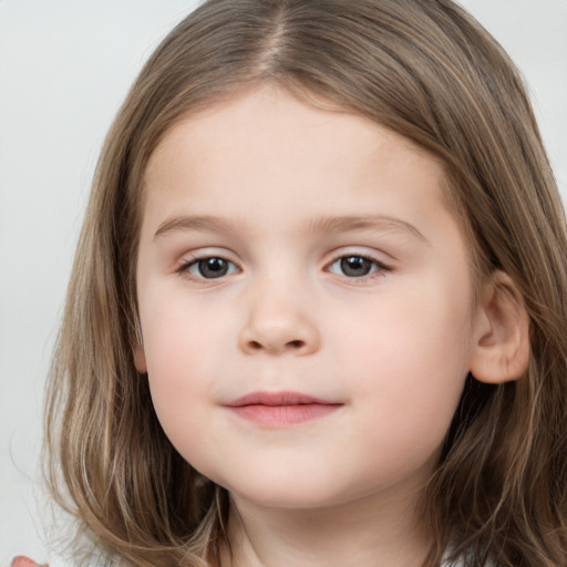 Joyful white child female with long  brown hair and brown eyes