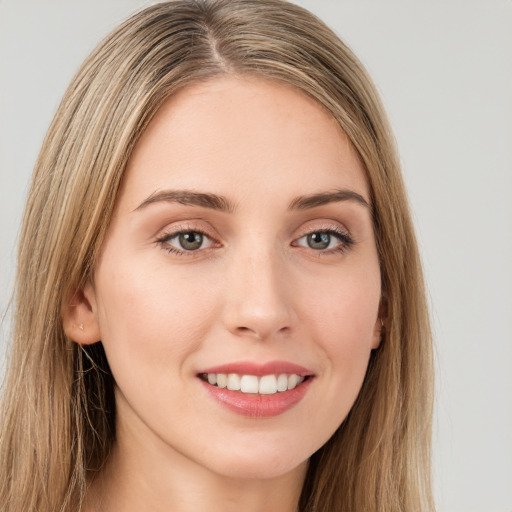 Joyful white young-adult female with long  brown hair and green eyes