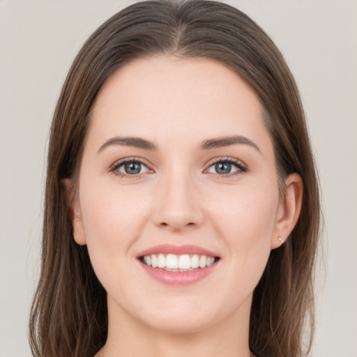 Joyful white young-adult female with long  brown hair and grey eyes