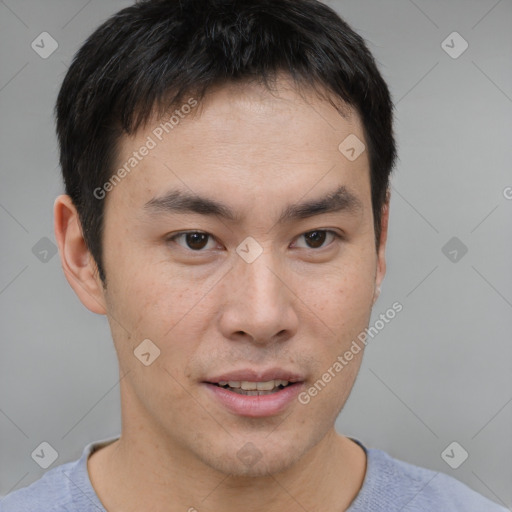 Joyful asian young-adult male with short  brown hair and brown eyes