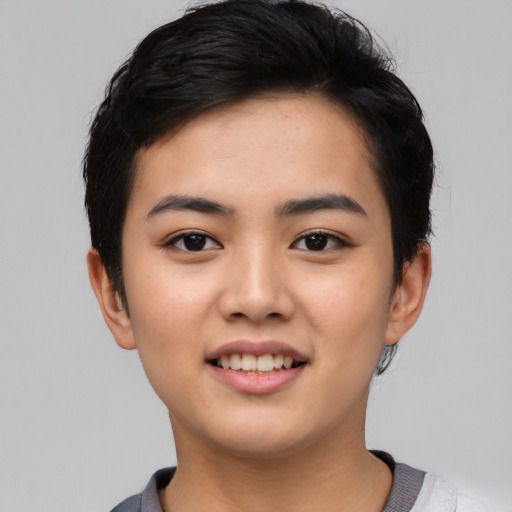 Joyful asian young-adult female with short  black hair and brown eyes