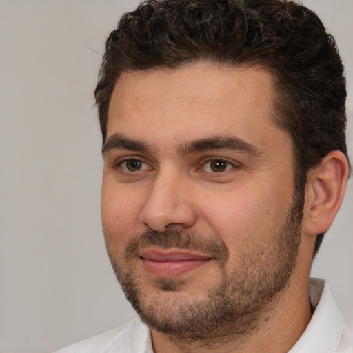 Joyful white adult male with short  brown hair and brown eyes