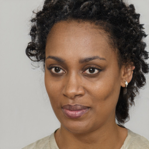Neutral black adult female with short  black hair and brown eyes