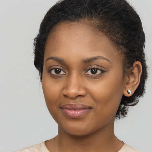 Joyful black young-adult female with medium  brown hair and brown eyes
