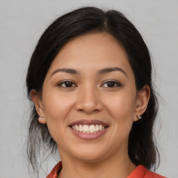 Joyful latino young-adult female with medium  brown hair and brown eyes