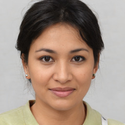 Joyful asian young-adult female with medium  brown hair and brown eyes