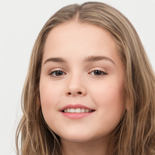 Joyful white child female with long  brown hair and brown eyes