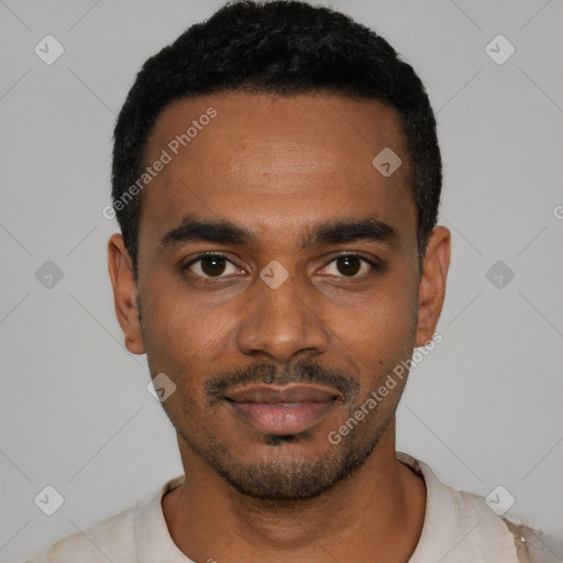 Joyful black young-adult male with short  black hair and brown eyes
