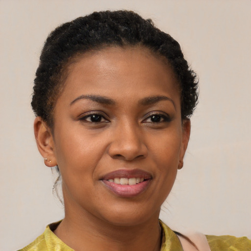 Joyful black young-adult female with short  brown hair and brown eyes