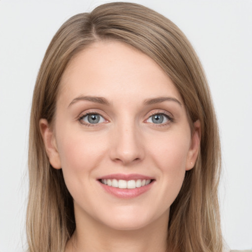 Joyful white young-adult female with long  brown hair and green eyes