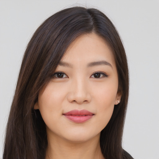 Joyful asian young-adult female with long  brown hair and brown eyes