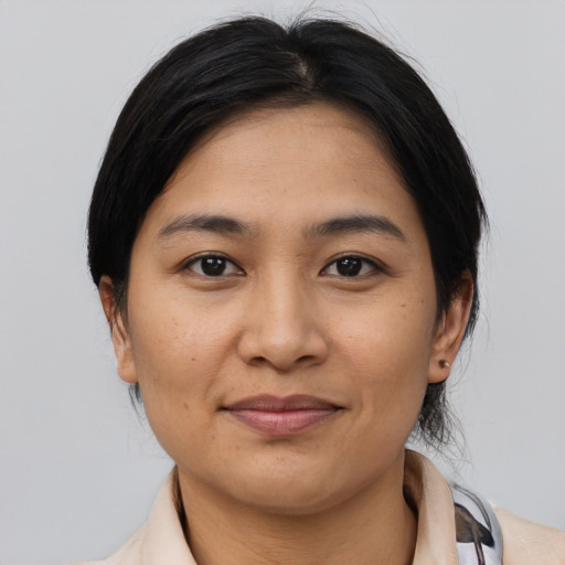 Joyful latino young-adult female with medium  black hair and brown eyes