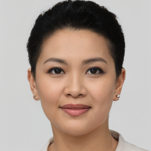 Joyful latino young-adult female with short  black hair and brown eyes