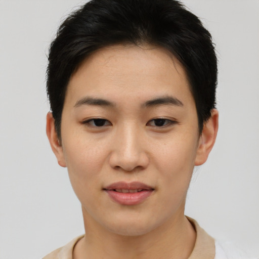 Joyful asian young-adult female with short  brown hair and brown eyes