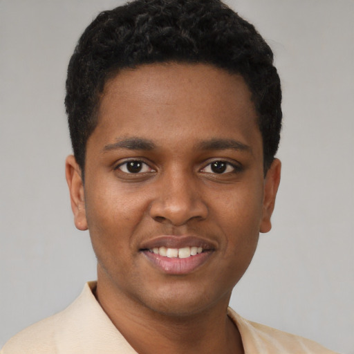 Joyful latino young-adult male with short  brown hair and brown eyes
