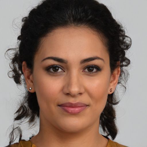 Joyful latino young-adult female with medium  brown hair and brown eyes