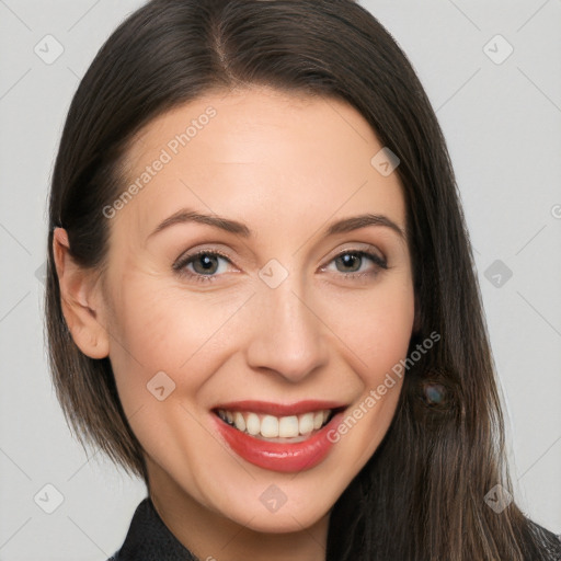 Joyful white adult female with long  brown hair and brown eyes