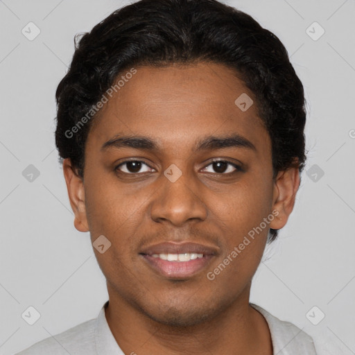 Joyful black young-adult male with short  brown hair and brown eyes