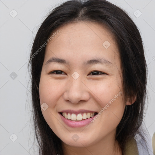 Joyful white young-adult female with long  brown hair and brown eyes