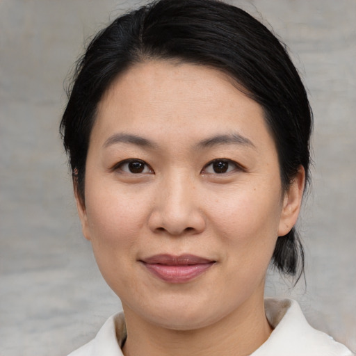 Joyful asian young-adult female with medium  black hair and brown eyes
