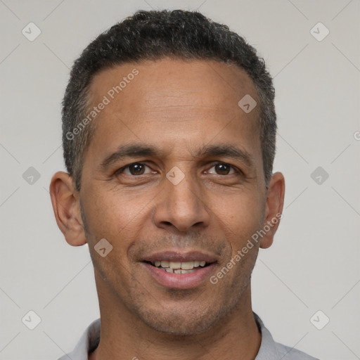 Joyful latino adult male with short  black hair and brown eyes