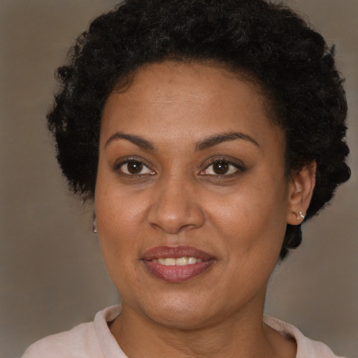 Joyful black adult female with short  brown hair and brown eyes