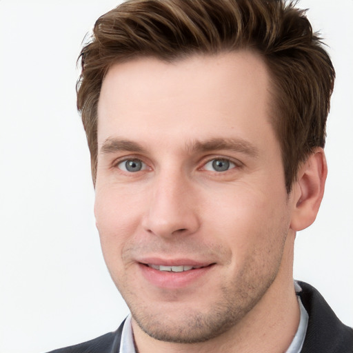 Joyful white young-adult male with short  brown hair and grey eyes