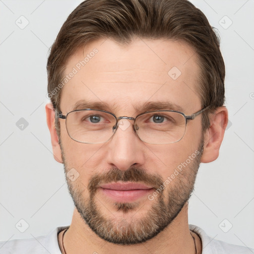 Joyful white adult male with short  brown hair and grey eyes