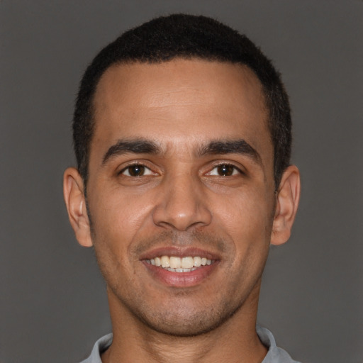 Joyful white young-adult male with short  black hair and brown eyes