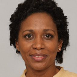 Joyful black adult female with short  brown hair and brown eyes