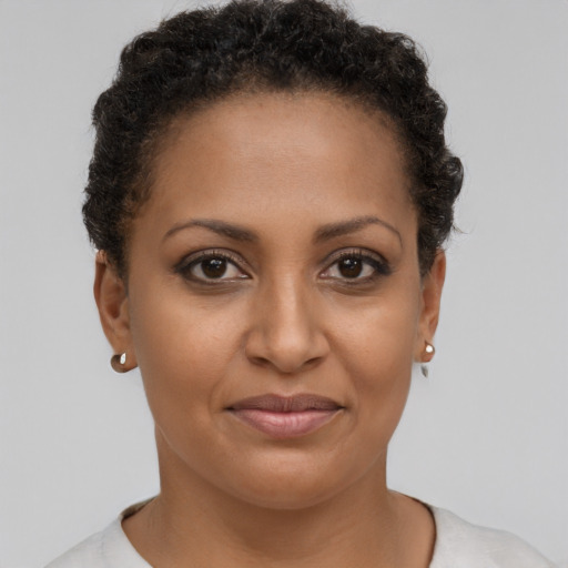 Joyful black young-adult female with short  brown hair and brown eyes