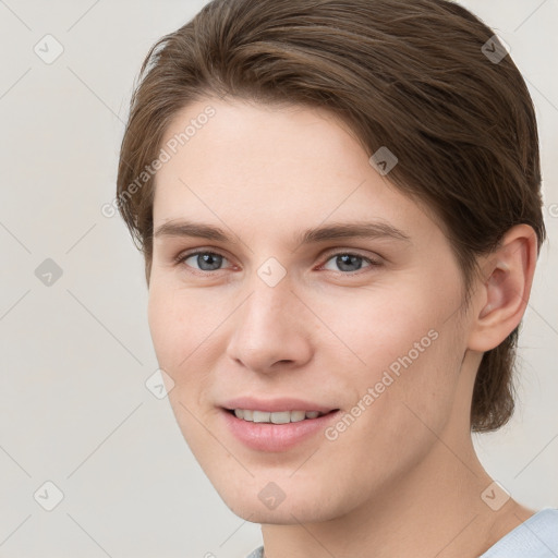 Joyful white young-adult female with short  brown hair and grey eyes