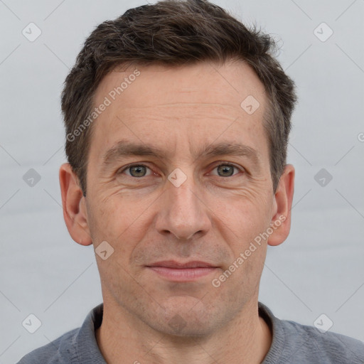 Joyful white adult male with short  brown hair and grey eyes