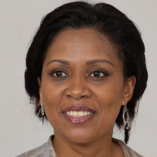 Joyful black adult female with medium  brown hair and brown eyes