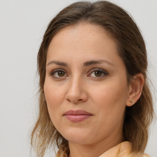Joyful white young-adult female with medium  brown hair and brown eyes