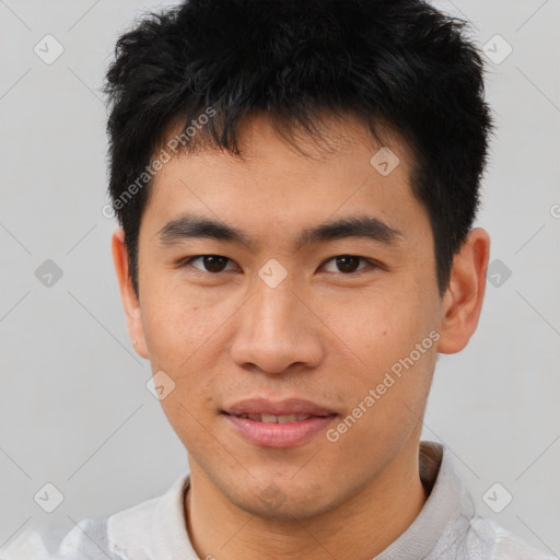 Joyful asian young-adult male with short  brown hair and brown eyes