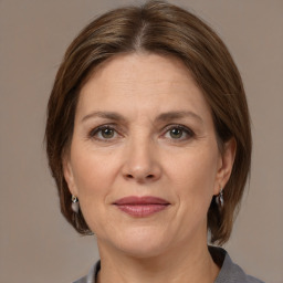 Joyful white adult female with medium  brown hair and grey eyes