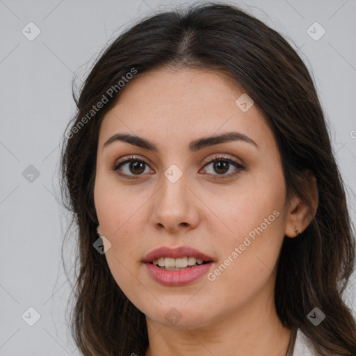 Joyful white young-adult female with long  brown hair and brown eyes