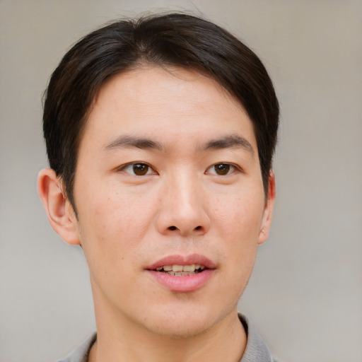 Joyful asian young-adult male with short  brown hair and brown eyes