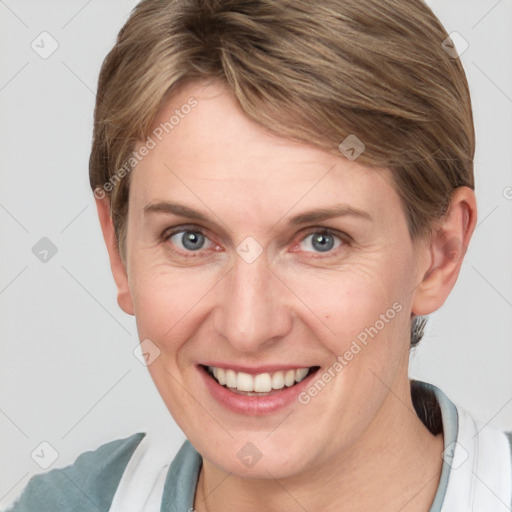 Joyful white adult female with short  brown hair and grey eyes