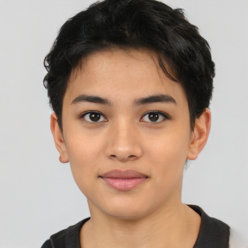 Joyful latino young-adult female with short  black hair and brown eyes