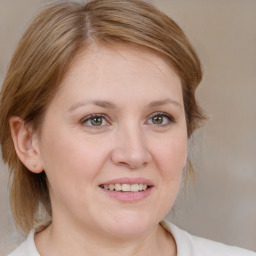 Joyful white young-adult female with medium  brown hair and blue eyes